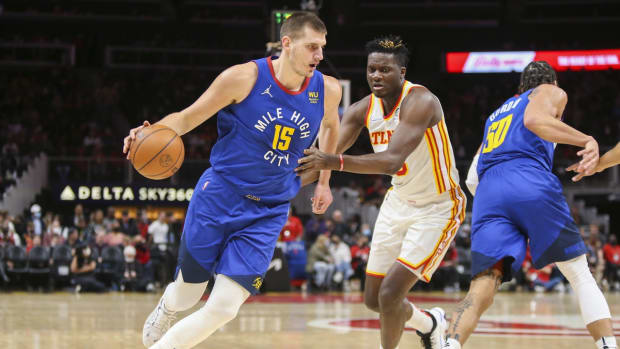 Dec 17, 2021; Atlanta, Georgia, USA; Denver Nuggets center Nikola Jokic (15) is defended by Atlanta Hawks center Clint Capela (15) in the first quarter at State Farm Arena. Mandatory Credit: Brett Davis-USA TODAY Sports